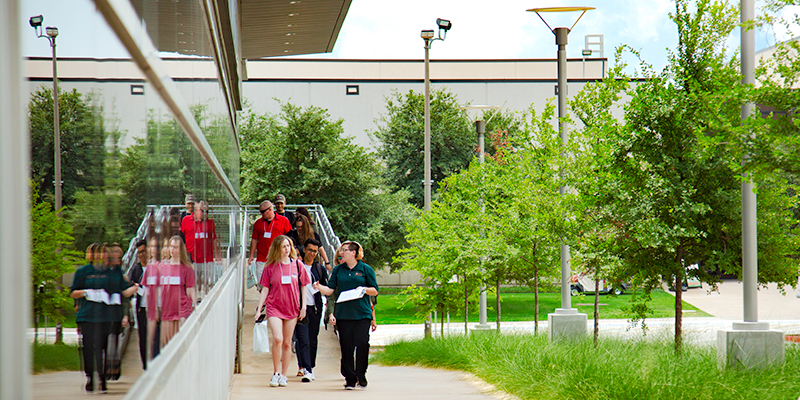 A group of prospective students being led on a campus tour by a student ambassador.